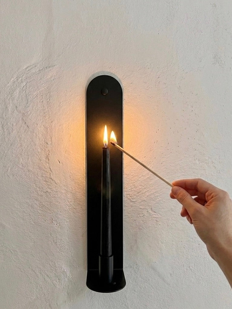 Black Ink Skinny wall sconce by Nomad Studio, candlelit ambiance, lifestyle photography.