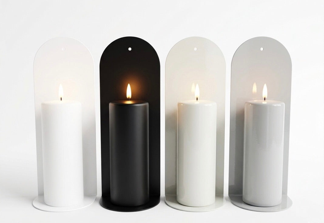 Four pillar candles on a powder coated wall sconce in white, grey, stone, black on a white background.