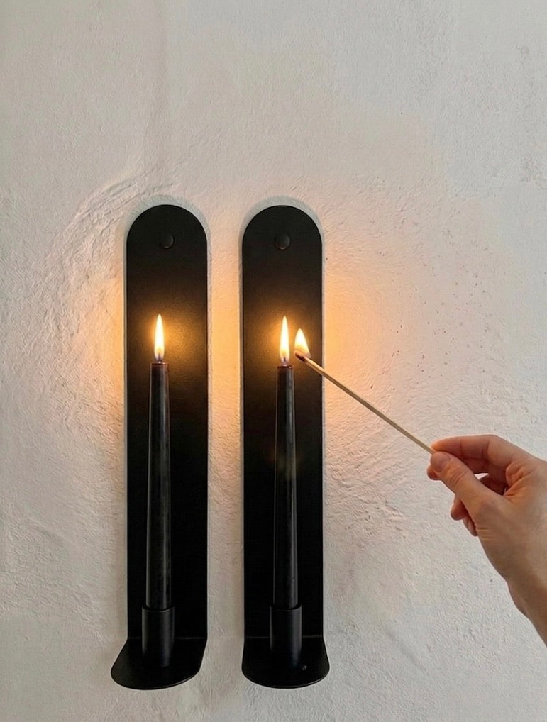 The Skinny wall sconce in Black Ink with illuminated candle.